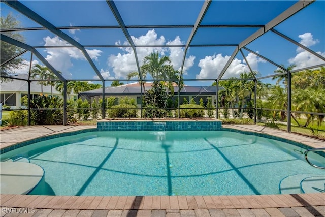 view of swimming pool with glass enclosure