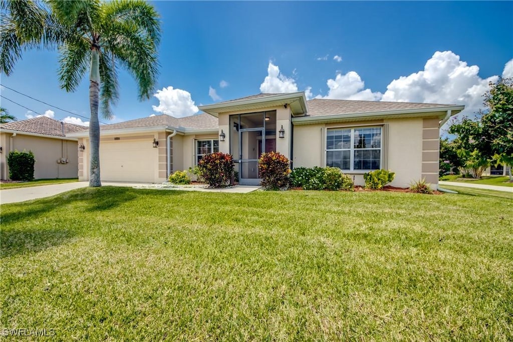 single story home featuring a front lawn and a garage