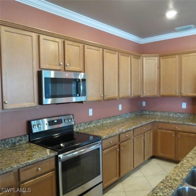 kitchen featuring light stone countertops, light tile patterned flooring, ornamental molding, and appliances with stainless steel finishes