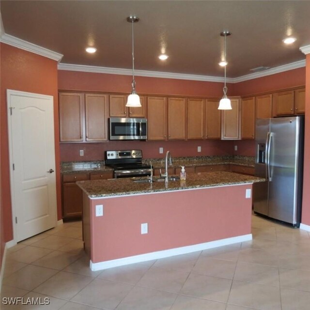 kitchen featuring pendant lighting, an island with sink, and appliances with stainless steel finishes