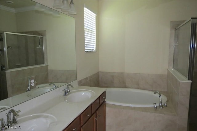 bathroom featuring vanity, crown molding, and shower with separate bathtub