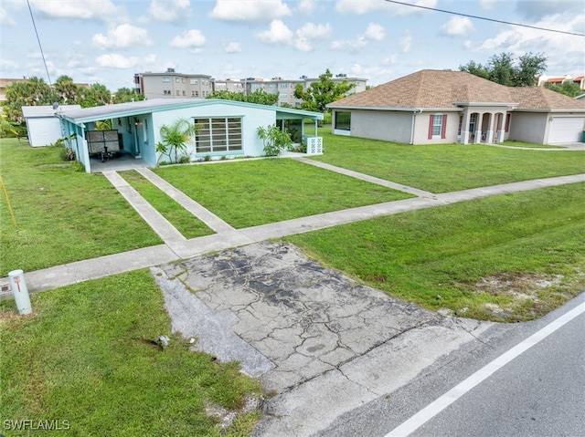 view of front of property featuring a front yard and a garage