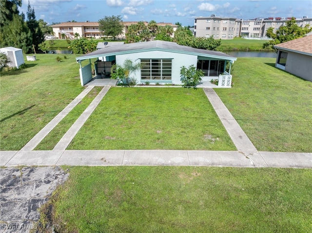 view of front of home featuring a front yard and a water view