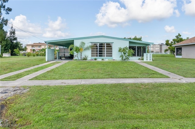 view of front of property with a front lawn and a carport