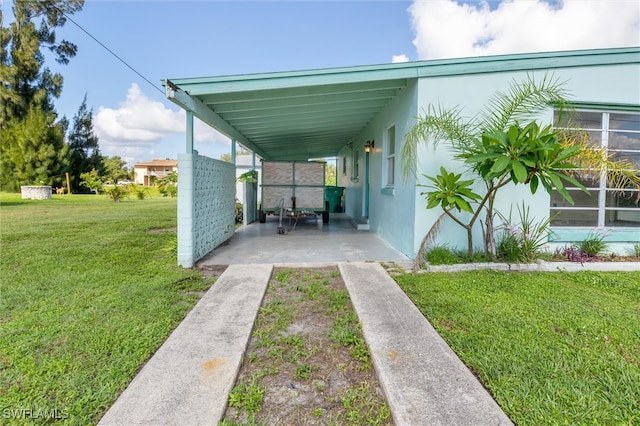 exterior space featuring a yard and a carport