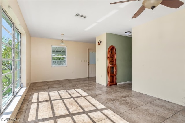 spare room featuring light tile patterned floors and ceiling fan