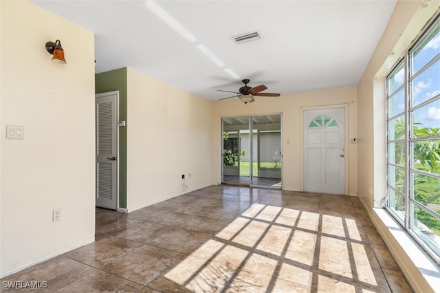 interior space featuring ceiling fan and plenty of natural light