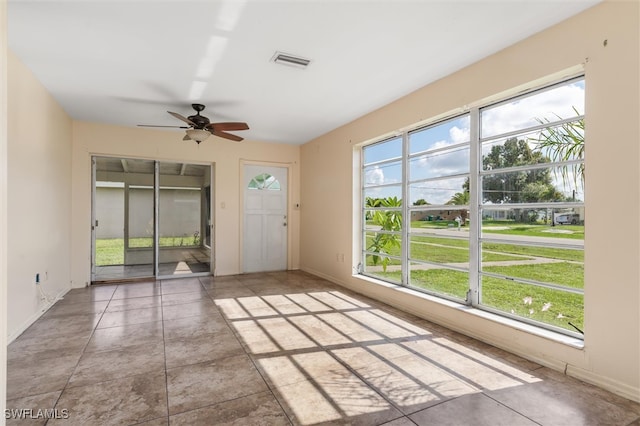 interior space featuring ceiling fan and a wealth of natural light