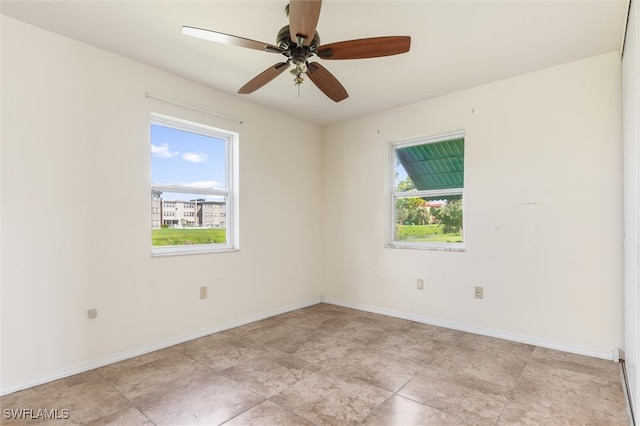 tiled spare room featuring ceiling fan