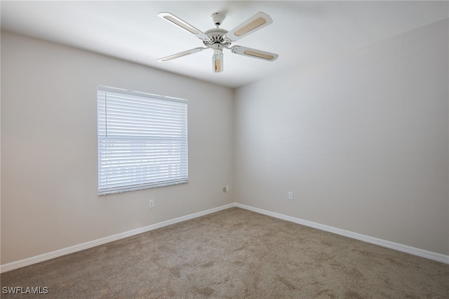 unfurnished room featuring light carpet and ceiling fan