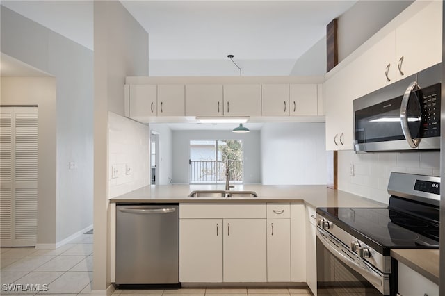 kitchen with backsplash, stainless steel appliances, sink, and light tile patterned floors