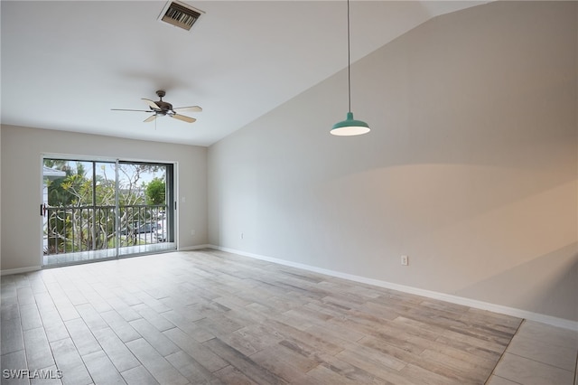 spare room featuring light hardwood / wood-style floors, lofted ceiling, and ceiling fan