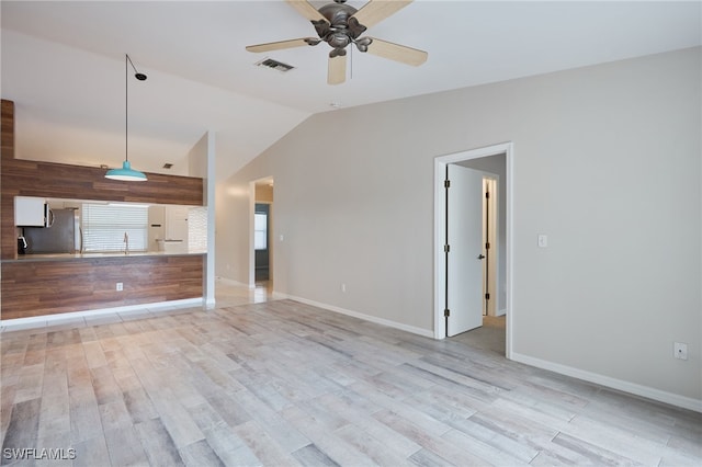 unfurnished living room with light hardwood / wood-style floors, vaulted ceiling, and ceiling fan