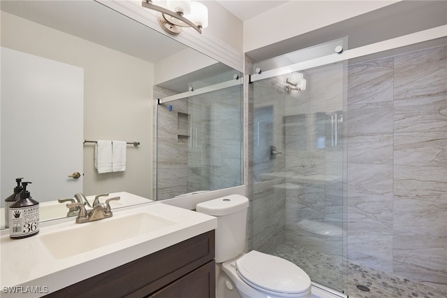 bathroom with vanity, toilet, and walk in shower