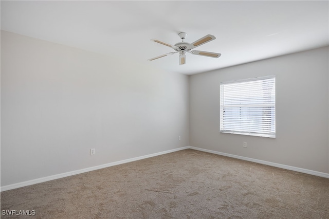 empty room featuring ceiling fan and carpet flooring