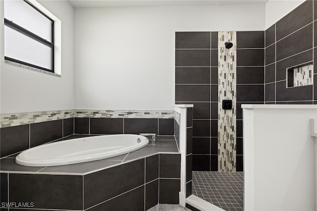 bathroom featuring shower with separate bathtub