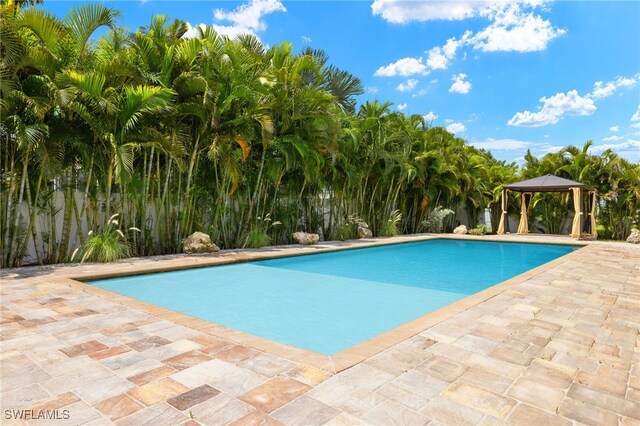 view of pool with a patio area and a gazebo