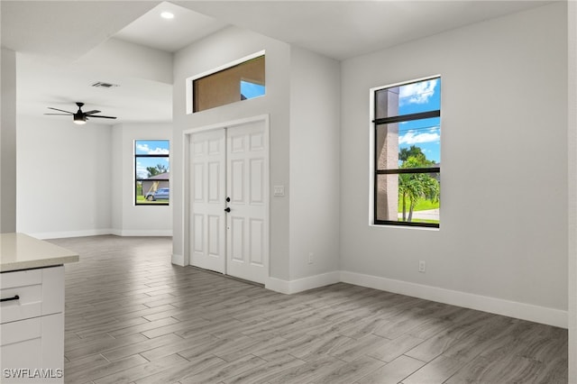 foyer entrance featuring light hardwood / wood-style floors and ceiling fan