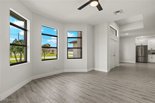 spare room featuring light hardwood / wood-style flooring and ceiling fan