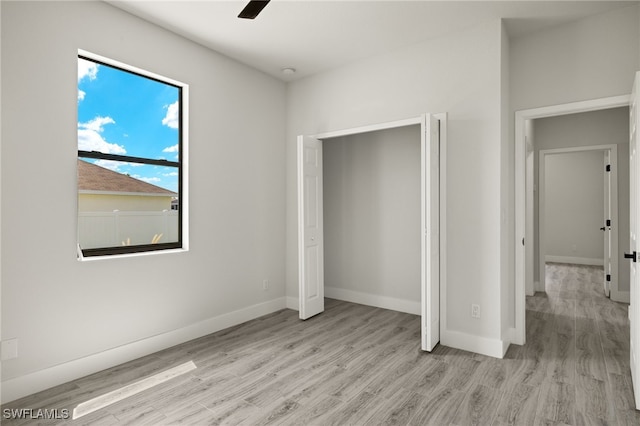 unfurnished bedroom featuring ceiling fan and light wood-type flooring