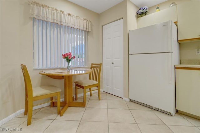 dining space featuring light tile patterned floors