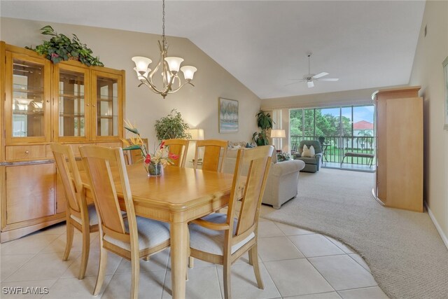 carpeted dining area featuring lofted ceiling and ceiling fan with notable chandelier