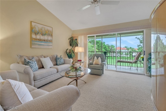 carpeted living room with ceiling fan and vaulted ceiling