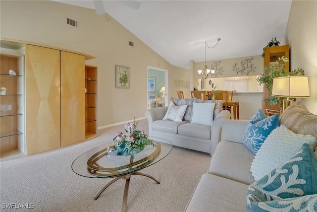 living room featuring high vaulted ceiling, carpet, and an inviting chandelier