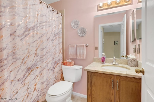 bathroom featuring toilet, vanity, and tile patterned flooring