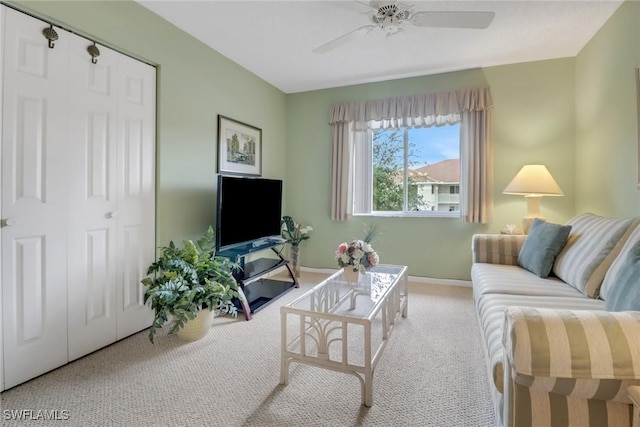 carpeted living room with ceiling fan