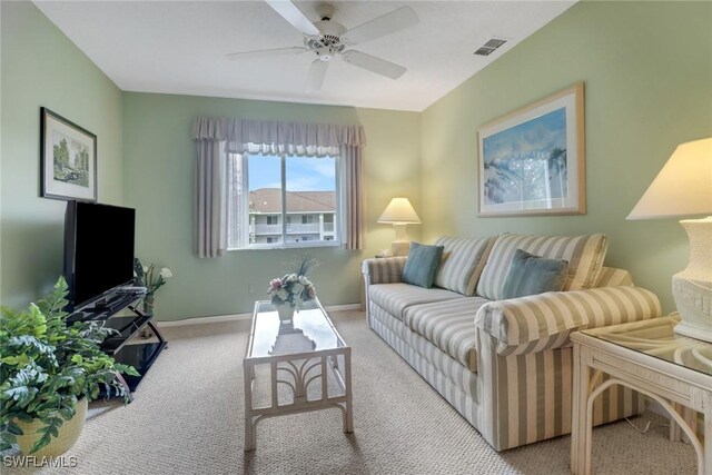 carpeted living room with ceiling fan