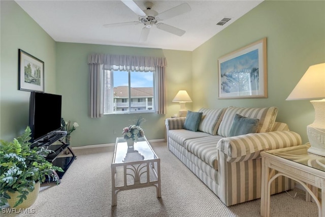 carpeted living room featuring ceiling fan