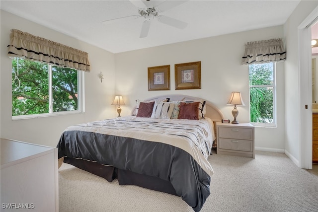 bedroom with ceiling fan and light colored carpet