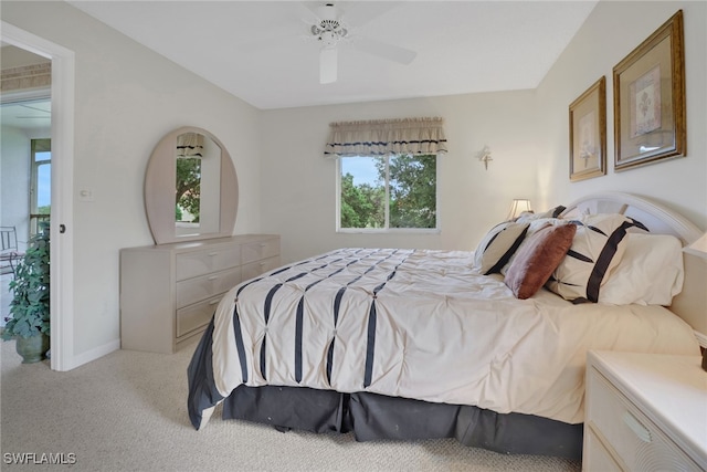 bedroom featuring light carpet and ceiling fan