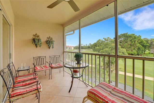 sunroom / solarium featuring ceiling fan