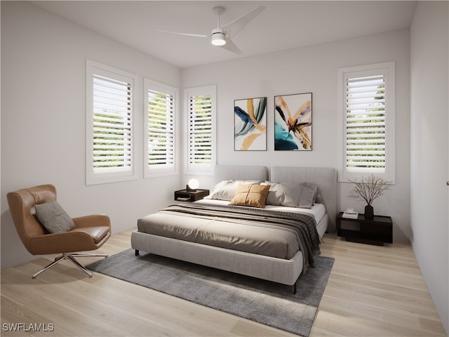 bedroom with light hardwood / wood-style floors, multiple windows, and ceiling fan