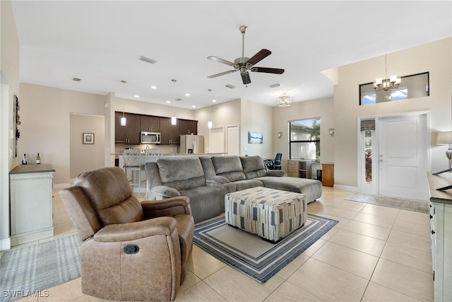 tiled living room featuring ceiling fan with notable chandelier