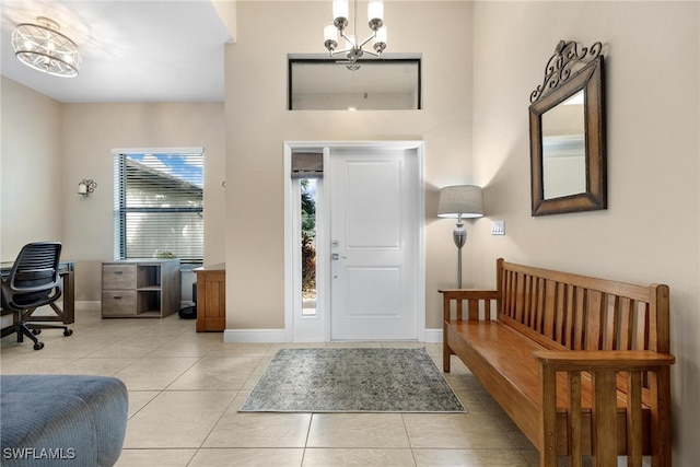 tiled entrance foyer featuring a chandelier