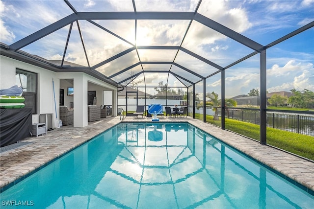 view of swimming pool with a patio area and glass enclosure