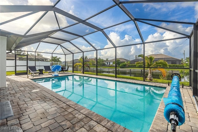 view of pool featuring a patio and glass enclosure