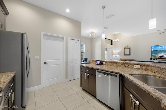 kitchen featuring dark brown cabinets, stainless steel appliances, hanging light fixtures, light stone countertops, and light tile patterned floors