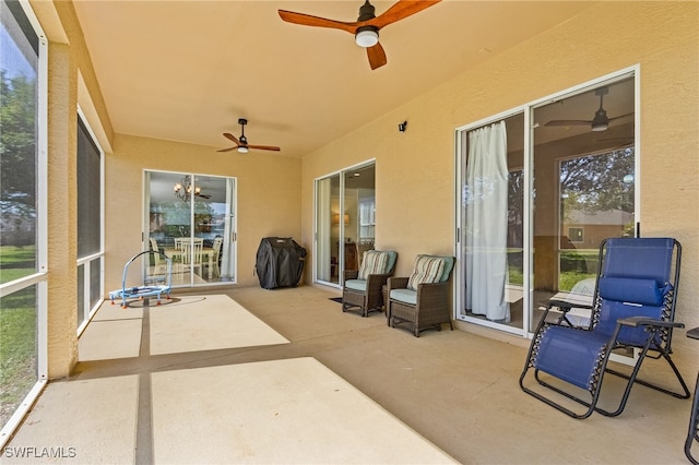 sunroom featuring ceiling fan and a wealth of natural light