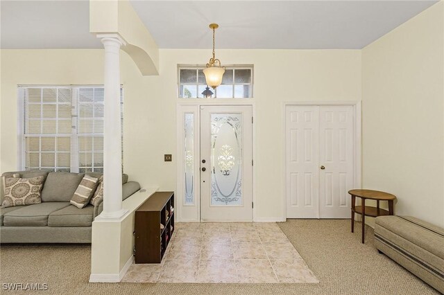 entrance foyer featuring decorative columns and light tile patterned flooring