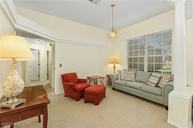 living room featuring ornate columns and light carpet