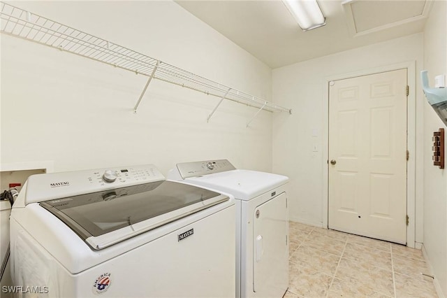 laundry area with light tile patterned floors and washer and dryer