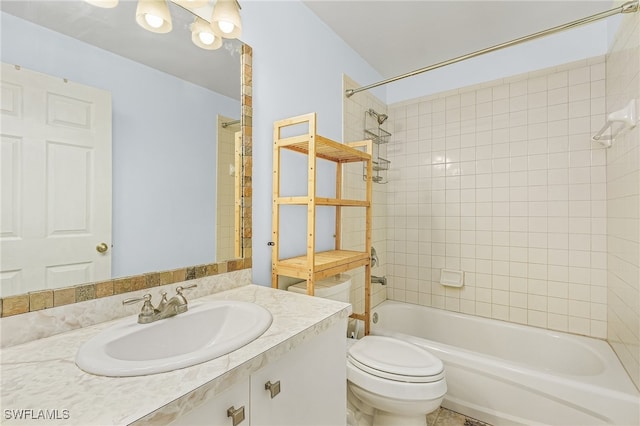 full bathroom featuring vanity, tiled shower / bath combo, and toilet