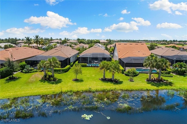 birds eye view of property with a residential view and a water view