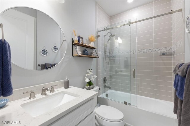 full bathroom featuring vanity, enclosed tub / shower combo, and toilet