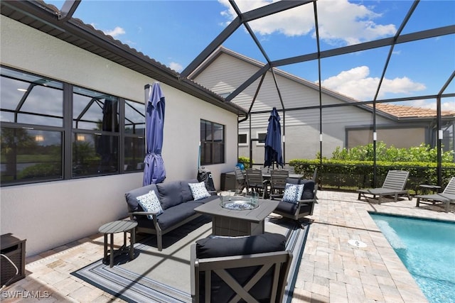 view of patio / terrace with a lanai, an outdoor living space with a fire pit, and an outdoor pool