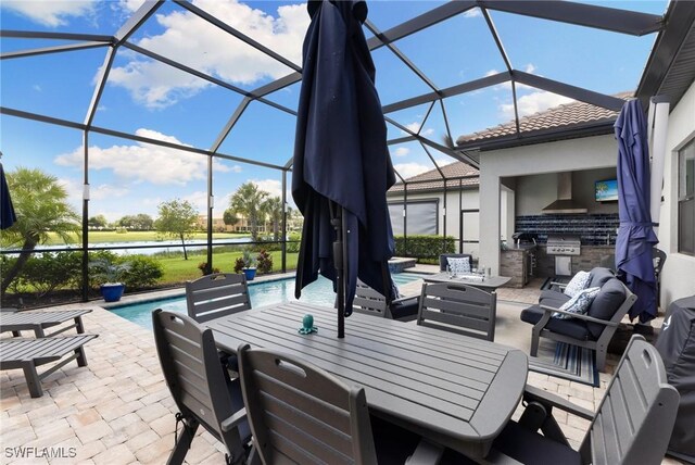 view of patio featuring an outdoor kitchen, a grill, and a lanai